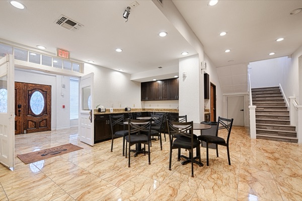 Guest lounge seating and breakfast area with staircase