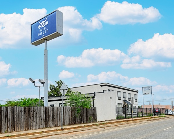 Hotel Dilley roadside sign against blue Texas sky