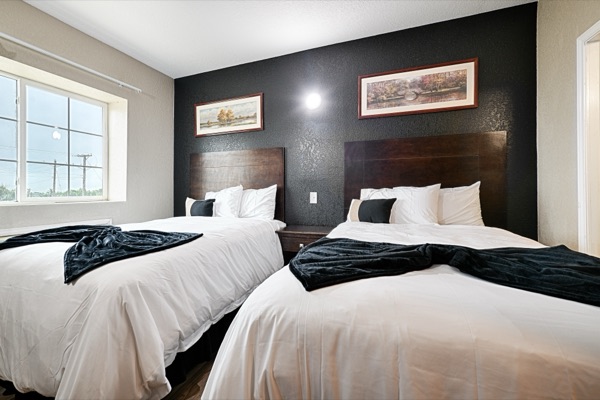 Corner room with two double beds and large windows