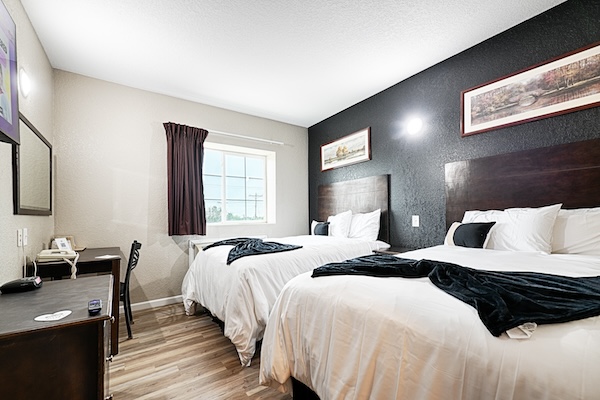 A furnished guest room at Hotel Dilley Grand
